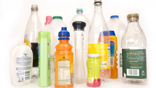 several plastic bottles including a fruit juice, milk and bottle of tonic
