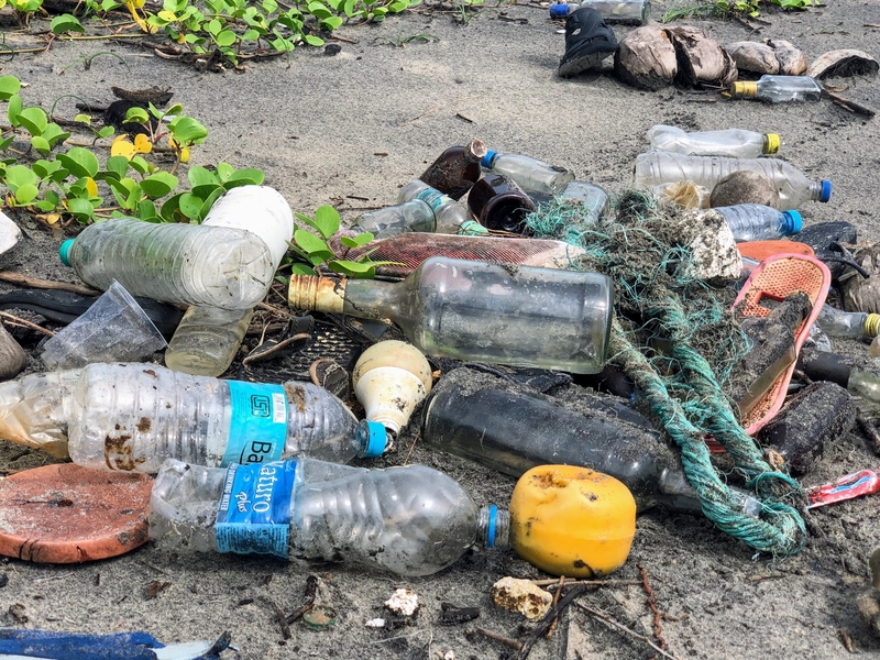 Plastic and glass waste on beach