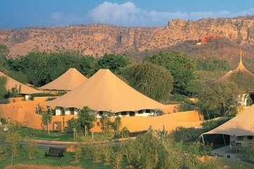 A luxury tent in a landscaped garden, rich with indigenous plants and birds.