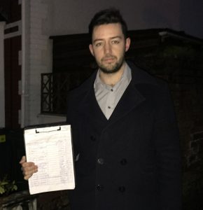 Ryan Allen holding his petition on Wauntreoda Road