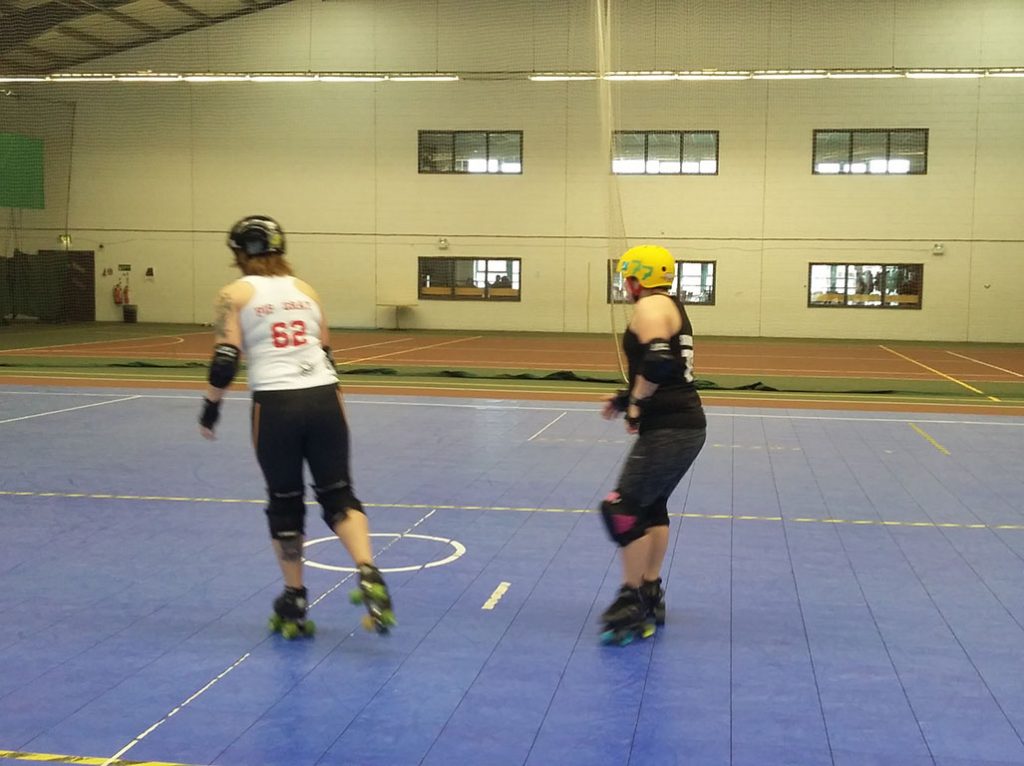 Two members of the Tiger Bay Brawlers practising at the community centre, on their team-funded floor
