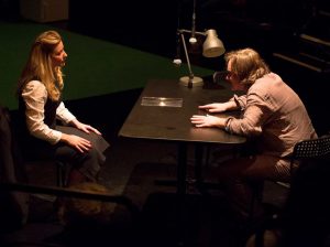 Stacey Daly as Detective Morris and Chris Durnall, the plays director, as Doyle at the interrogation table.