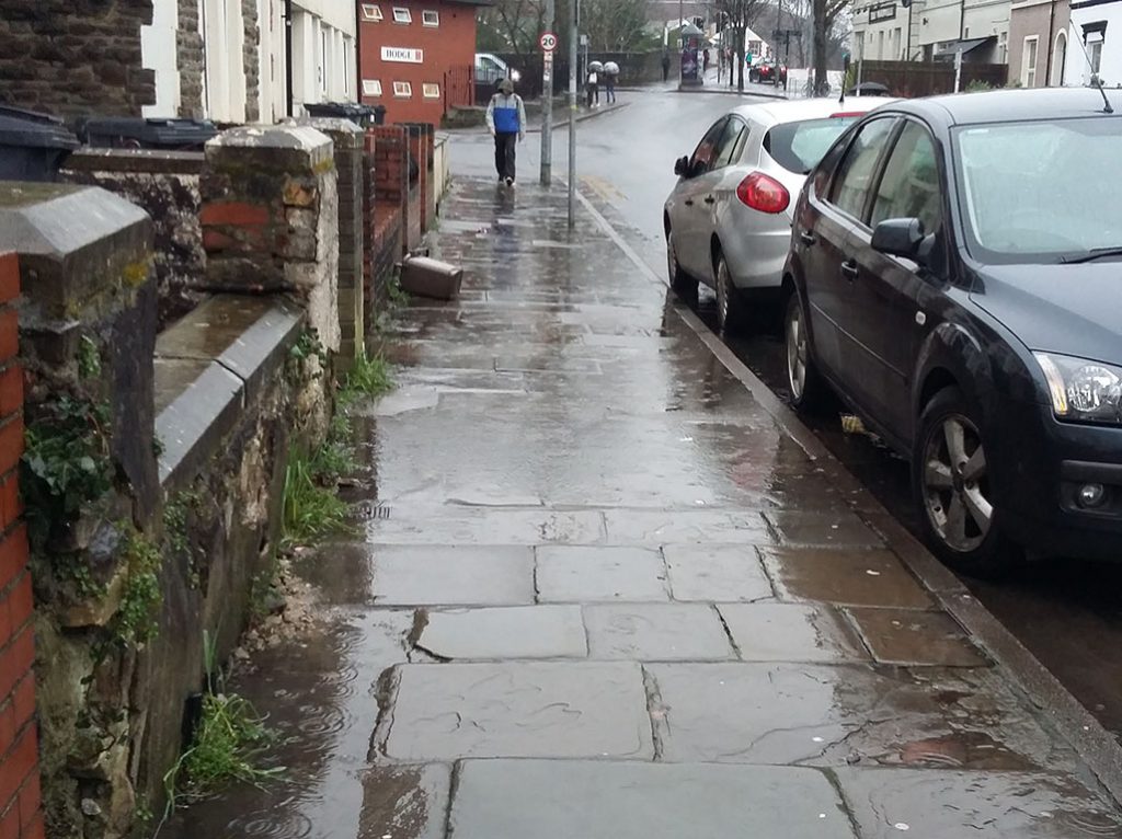 On Woodville Road, the uneven pavement collects the water from heavy rain and can’t drain away.
