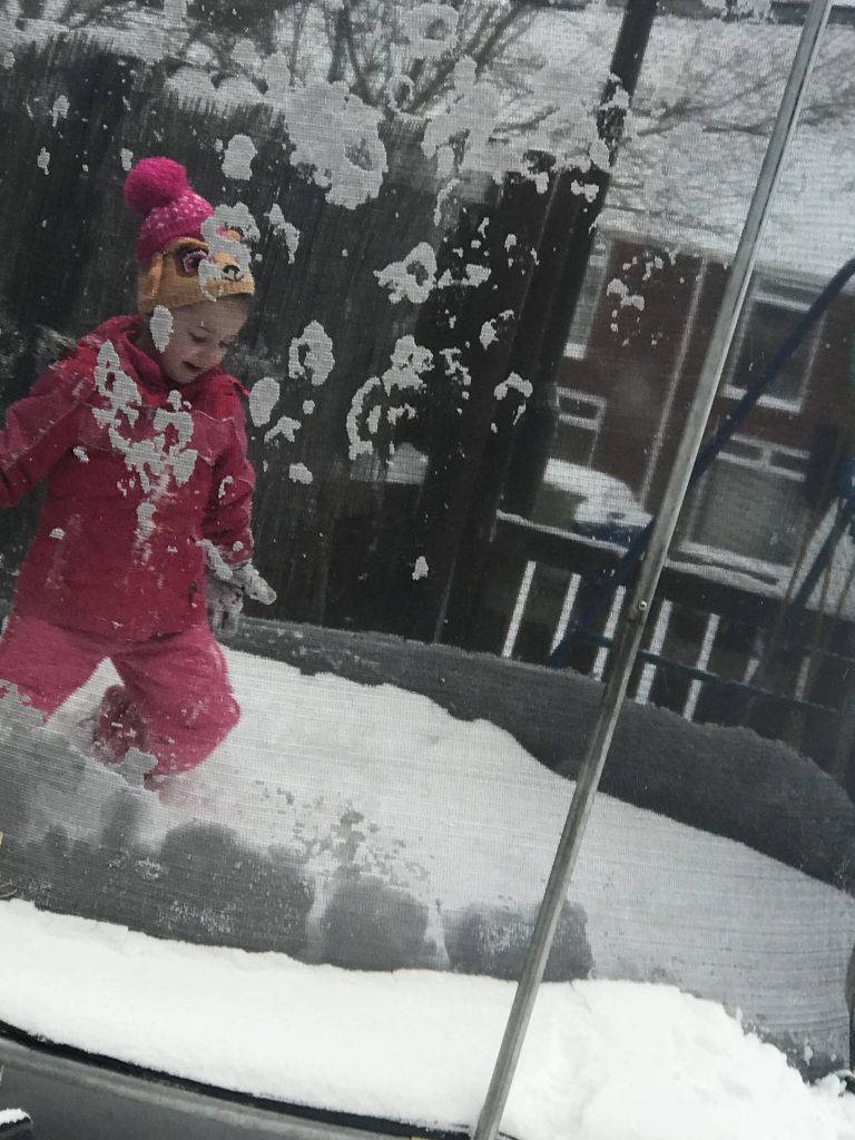 Kensie, 5, plays on a trampoline in the snow in Washington, Tyne and Wear. Credit: Sue Lockwood