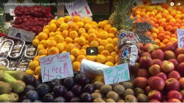 Colourful fruit stall with satsumas