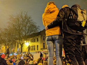 A couple overlooking the protesters on Queen Street