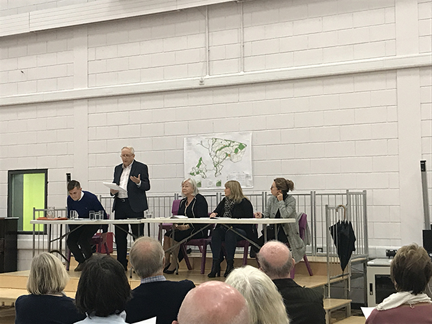 Councillors Joel Williams, David Walker and Dianne Rees at the front of the hall, leading the meeting.